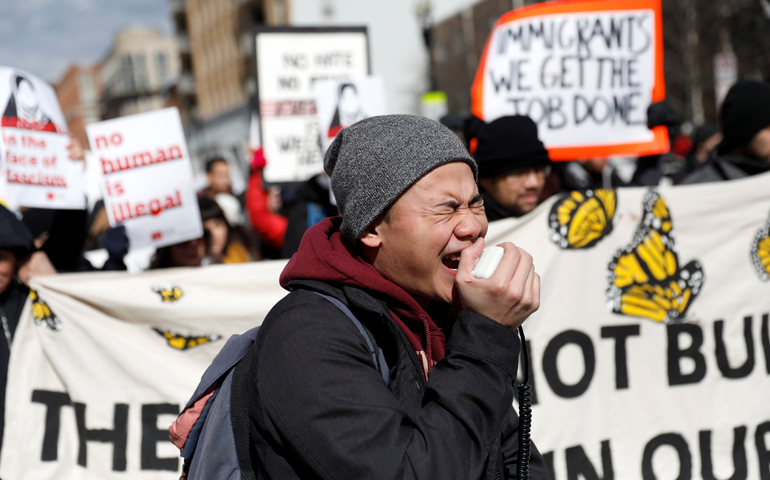 A demonstrator yells into a loudspeaker during the "Day Without Immigrants" protest Feb. 16 in Washington. (CNS/Aaron P. Bernstein, Reuters)