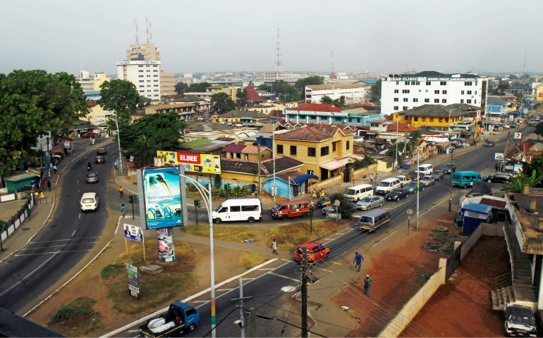 Cars and people travel through a business area in 2016 in Accra, Ghana. In preparation for Ghana's 60th anniversary celebration March 6, members of the Ghana Bishops' Conference have called on Ghanaians to continue to make the nation truly the "Star of Africa," a symbol of hope for Africa's total liberation. (CNS photo/Luc Gnago, Reuters)