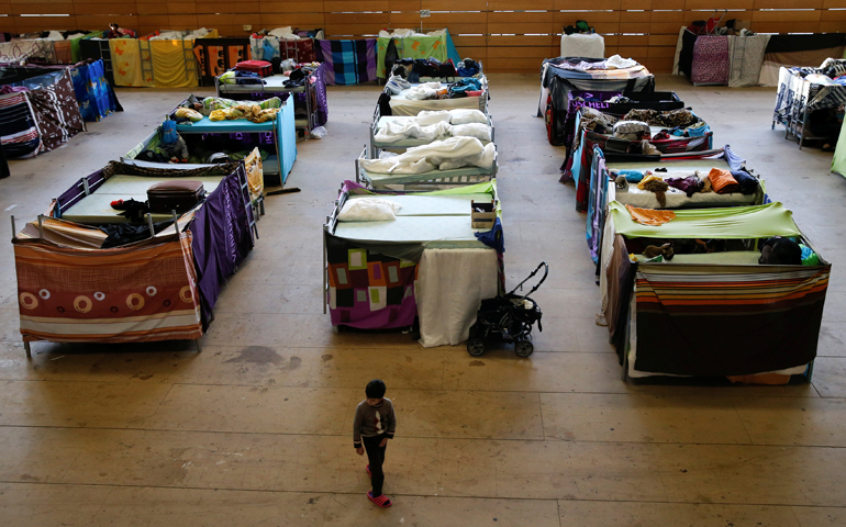 A migrant child walks in a refugee shelter in a school gym in Berlin in this Feb. 2, 2016, file photo. (CNS/Fabrizio Bensch, Reuters)