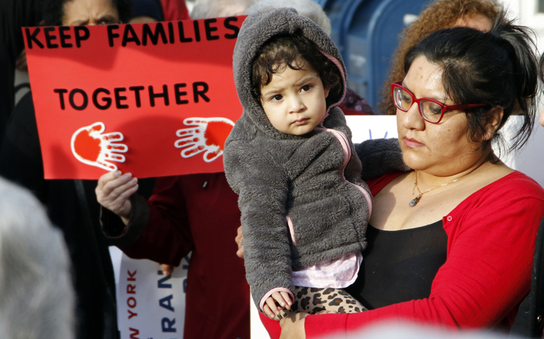 Victoria Daza, a native of Peru and an immigrants' rights activist, holds her daughter during a rally in support of immigrants in Massapequa Park, N.Y., Feb. 24.