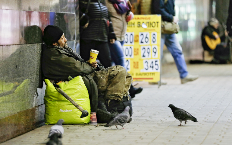 A homeless Ukrainian man collects money Feb. 9 in downtown Kiev. (CNS/EPA/Sergey Dolzhenko)