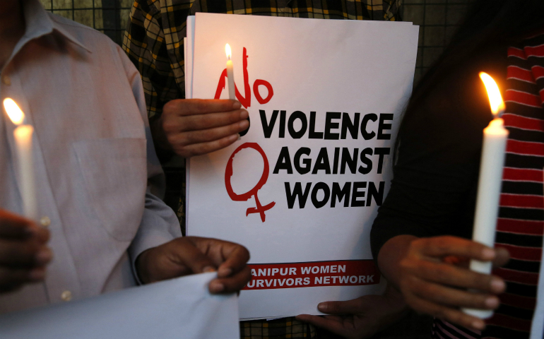 CNS photo/Rajat Gupta, EPA Indian activists protest a rape incident in New Delhi, India, Feb. 21. Police in southern Kerala state arrested a 48-year-old priest and charged him with rape of a minor after a teen girl in his parish delivered a baby. (CNS photo/Rajat Gupta, EPA)