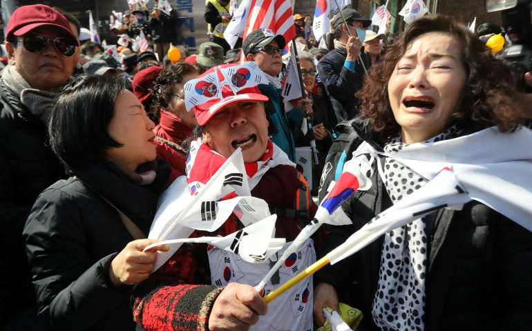 Supporters of South Korean President Park Geun-Hye react in front of the Constitutional Court in Seoul March 10 after hearing that the president's impeachment was upheld. A South Korean court removed the president that day, a first in the nation's history, rattling the delicate balance of relationships across Asia at a particularly tense time. (CNS photo/Lim Se-young via Reuters)