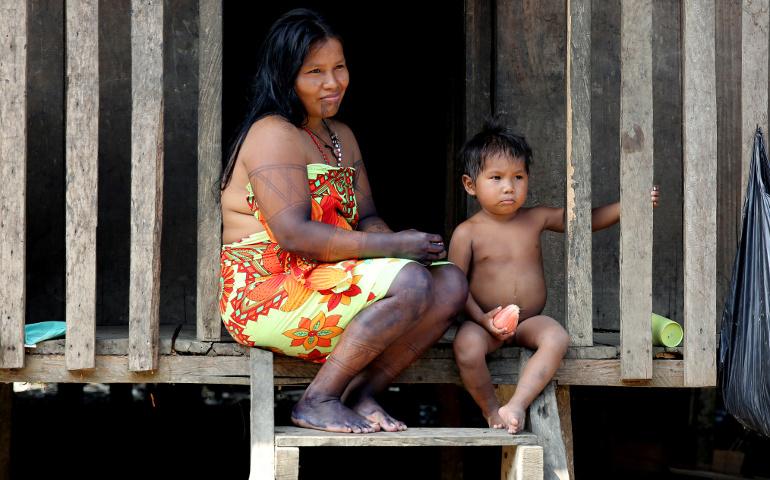 An Embera indigenous woman sits with her son March 18 outside their home in Quibdo, Colombia. Blessed Paul VI's 1967 encyclical "Populorum Progressio" rooted the Catholic Church in solidarity with the world's poorest nations. (CNS/Leonardo Munoz, EPA)