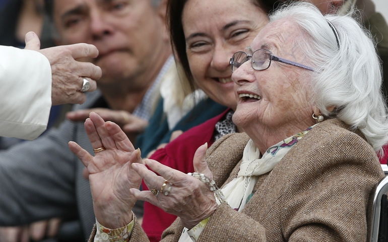 An elderly woman reacts as she meets Pope Francis during his general audience in St. Peter's Square at the Vatican March 22. (CNS photo/Paul Haring)
