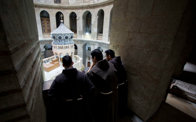 Men religious watch a ceremony in Jerusalem's Old City marking the end of restoration work on the site of Jesus' tomb at the Church of the Holy Sepulcher March 22. (CNS photo/Sebastian Scheiner, Reuters)