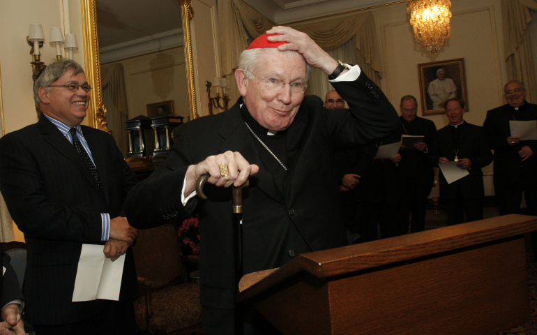 Cardinal William H. Keeler, retired archbishop of Baltimore, places a zucchetto on his head as he prepares to offer the opening prayer during a prayer service for Catholic and Jewish leaders hosted by New York Archbishop Timothy M. Dolan at his residence in New York May 12, 2009. Cardinal Keeler died March 23. He was 86. (CNS photo/Gregory A. Shemitz)