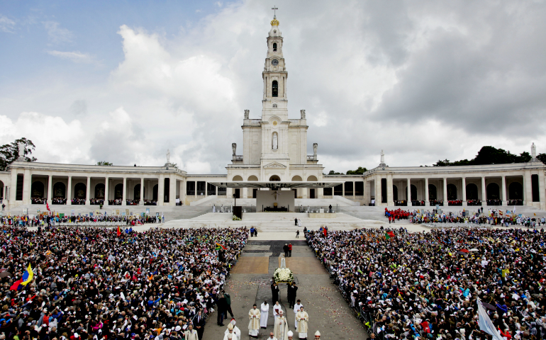 A statue of Our Lady of Fatima is carried through a crowd in 2016 at the shrine of Fatima in Portugal. (CNS/EPA/Paulo Chunho)