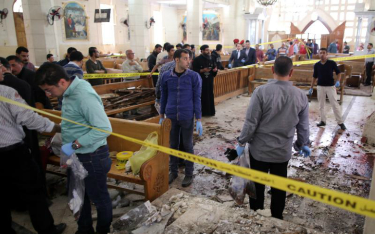 Security personnel investigate the scene of a bomb explosion April 9 inside the Orthodox Church of St. George in Tanta, Egypt. That same day an explosion went off outside the Cathedral of St. Mark in Alexandria where Coptic Orthodox Pope Tawadros II was presiding over the Palm Sunday service. (CNS photo/Khaled Elfiqi, EPA) 