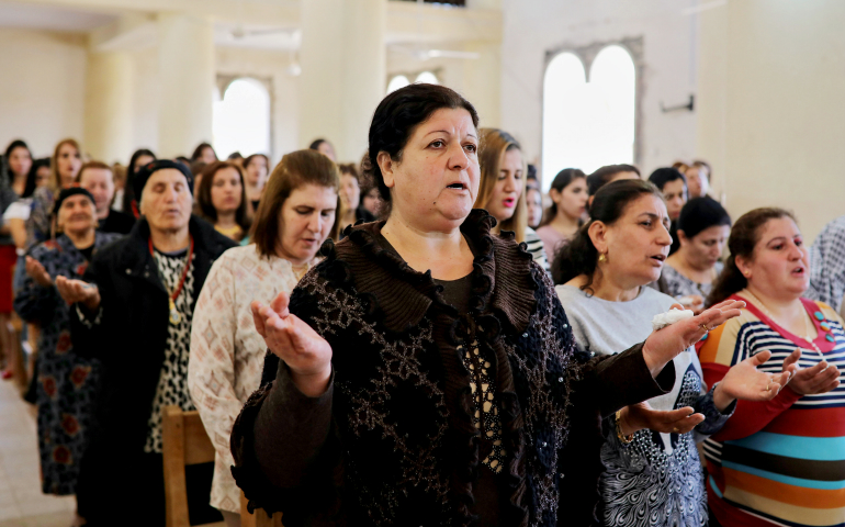 Worshipers pray during Easter Mass April 16 in St. George Chaldean Catholic church in Tel Esqof, Iraq. The church was damaged by Islamic State militants. (CNS/Reuters/Marko Djurica)