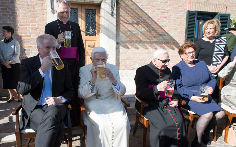 Retired Pope Benedict XVI enjoys a beer during his his 90th birthday celebration April 17 at the Vatican. Also pictured is his brother, Msgr. Georg Ratzinger, at the pope's left, and Archbishop Georg Ganswein, prefect of the papal household, in rear. (CNS/L'Osservatore Romano)