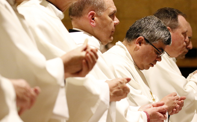 Priests hold the Eucharist during a Mass of Hope and Healing for victims of sex abuse April 26 at St. Anselm Church in Brooklyn, N.Y. (CNS/Gregory A. Shemitz)