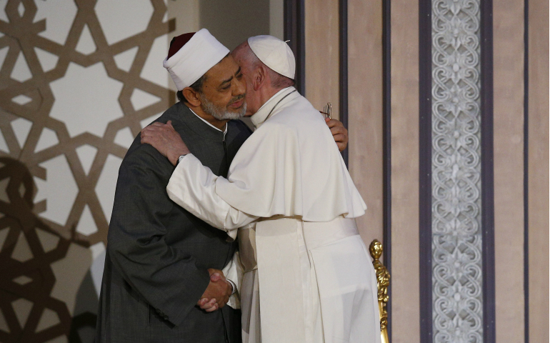 Pope Francis embraces Sheik Ahmad el-Tayeb, grand imam of al-Azhar University, at a conference on international peace in Cairo April 28, during his visit to Egypt. (CNS/Paul Haring)