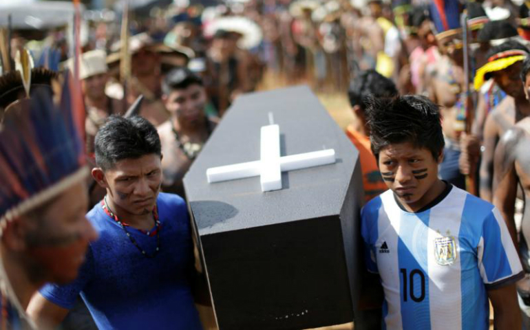 Brazilian Indians in Brasilia carry a symbolic coffin April 25 to show the death of indigenous rights in their country. (CNS/Ueslei Marcelino, Reuters)