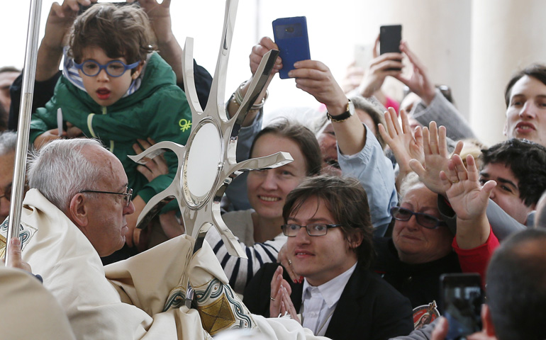 Pope Francis blesses the sick with the Eucharist at the canonization Mass of Fatima seers Sts. Francisco and Jacinta Marto, at the Shrine of Our Lady of Fatima, May 13 in Portugal. (CNS/Paul Haring)