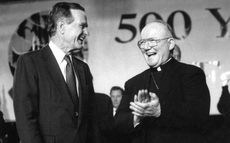 Bishop Thomas Daily of Brooklyn, N.Y., applauds as he shares a laugh with President George H. Bush in 1992. (CNS/Ed Wilkinson, The Tablet)
