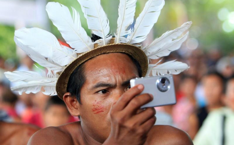 An indigenous member of the Desano ethnic group handles a camera during a meeting in Mitu, Colombia, Aug. 19, 2016. (CNS/Mauricio Duenas Castaneda, EPA)