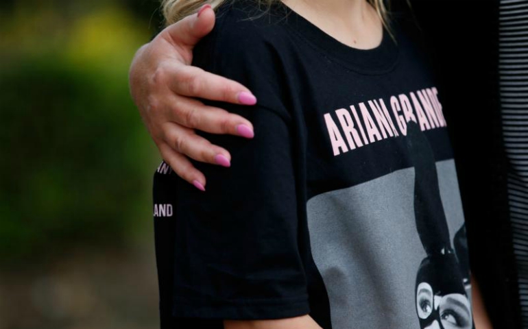 A young concertgoer wearing a T-shirt showing U.S. singer Ariana Grande talks to the media near Manchester Arena in England May 23. (CNS/Andrew Yates, Reuters)