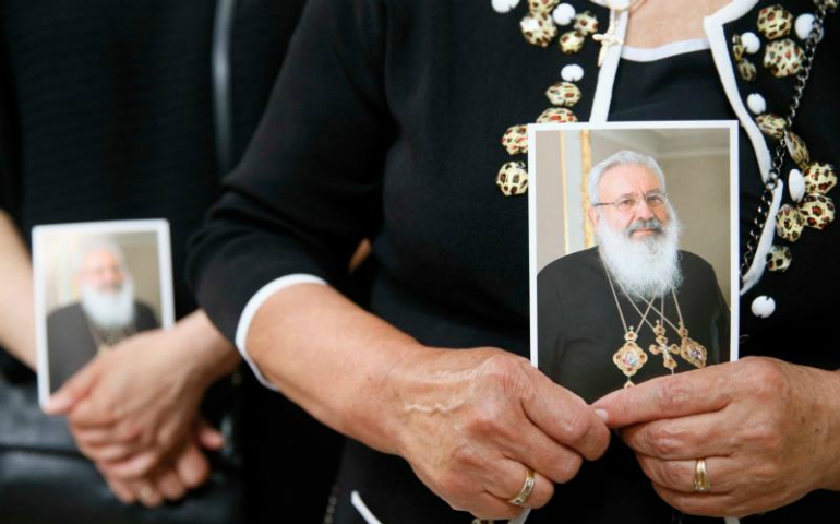 A woman holds an image of Ukrainian Cardinal Lubomyr Husar during his June 5 funeral Mass at the Patriarchal Cathedral of the Resurrection of Christ in Kiev. (CNS/Valentyn Ogirenko, Reuters)
