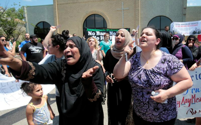 Women react as they talk about family members who were arrested by immigration officials during a June 12 rally outside the Mother of God Chaldean Catholic Church in Southfield, Michigan. (CNS/Rebecca Cook, Reuters)