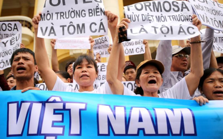 Vietnamese protesters hold banners during a 2016 rally in Hanoi denouncing mass fish deaths due to toxic discharge from the Taiwanese-built steel plant in Ha Tinh province. (CNS/Luong Thai Linh, EPA)