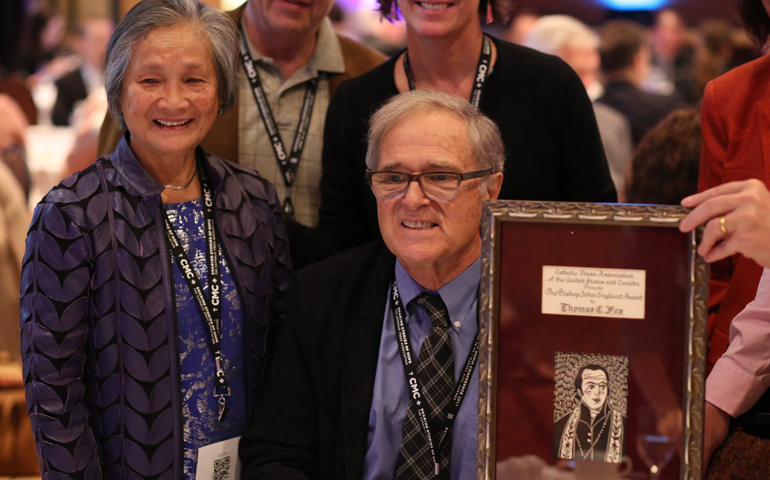 Thomas C. Fox, former publisher of the National Catholic Reporter, poses with wife, Kim Hoa, after receiving the Bishop John England award June 22 at the Catholic Media Conference in Quebec City. (CNS/Philippe Vaillancourt, Presence)