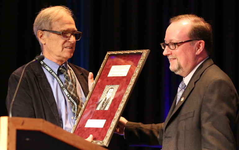 Joe Towalski, incoming president of the Catholic Press Association, right, presents the Bishop John England award to Thomas C. Fox June 22 at the Catholic Media Conference in Quebec City. (CNS/ Presence/Philippe Vaillancourt)