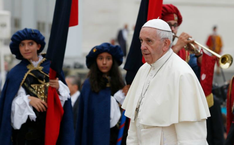 Pope Francis walks past traditional flag twirlers and musicians during his general audience in St. Peter's Square at the Vatican June 28. (CNS/Paul Haring)
