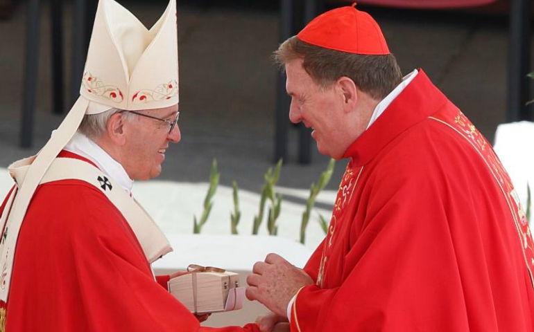 Pope Francis presents a box containing a pallium to Cardinal Joseph Tobin of Newark, N.J., at the conclusion of Mass marking the feast of Sts. Peter and Paul in St. Peter's Square at the Vatican June 29. ((CNS/Paul Haring)