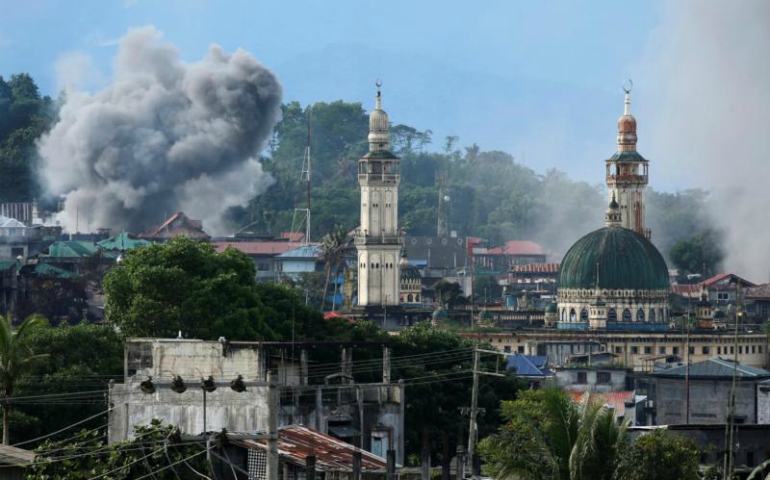Smoke is seen following a Philippine Army airstrike June 29 as government troops continue their assault against Islamic militants in Marawi. (CNS/Jorge Silva, Reuters)