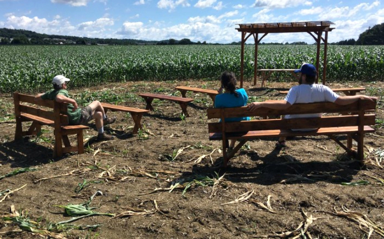 People sit at an outdoor chapel on the property of the Adorers of the Blood of Christ in Columbia, Pennsylvania, in early July. The chapel was built as a symbol to block the Atlantic Sunrise natural gas pipeline. (CNS/Courtesy of Lancaster Against Pipelines/Mark Clatterbuck)