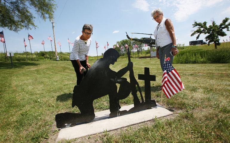 Srs. Shirley Citrowski and Carol Speich pause to look at a monument of a soldier at Veterans Memorial Park in Belle Plaine, Minnesota, June 9. (CNS/Dave Hrbacek, The Catholic Spirit)