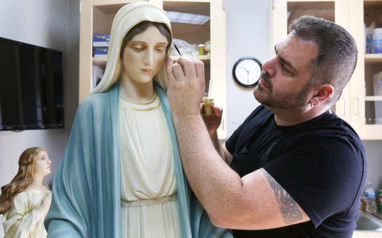 Artist Lou McClung paints a statue of Mary in his studio at the Museum of Divine Statues in Lakewood, Ohio, July 18. (CNS /courtesy Lou McClung, Museum of Divine Statues)