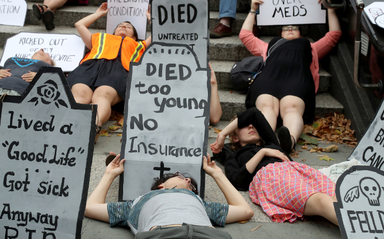 People illustrate the importance of affordable health care in New York City July 13. (CNS photo / Andrew Gombert, EPA) 
