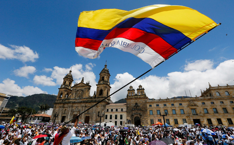 A man waves a Colombian flag in Bogota, Colombia, in this 2015 file photo. Pope Francis will beatify Bishop Jesus Emilio Jaramillo Monsalve of Arauca and Fr. Pedro Ramirez Ramos in the South American country Sept. 8. (CNS/John Vizcaino, Reuters) 