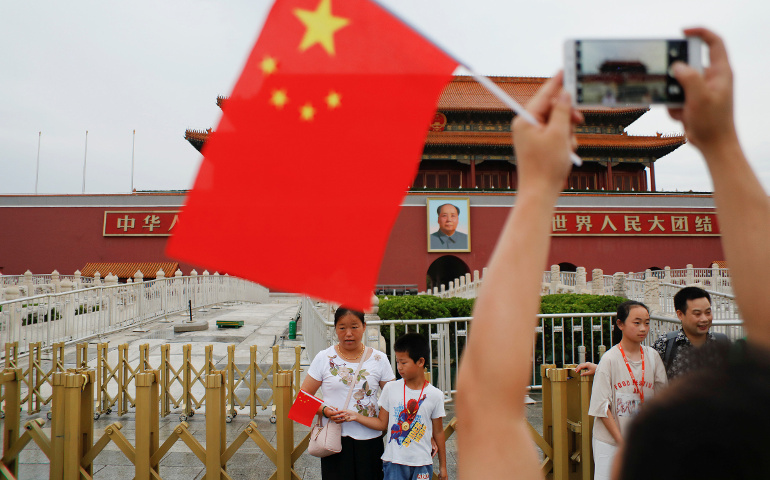 People are seen at the Tiananmen Gate in Beijing July 14. A Chinese communist party official indicated July 19 that Beijing intends to retain tight grip on the Catholic Church. (CNS/Damir Sagolj, Reuters)
