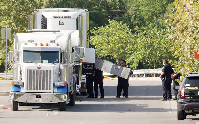 Police officers in San Antonio work a crime scene at Walmart July 23 after eight people were found dead inside an 18-wheeler truck. The death toll reached 10 as of early July 24. (CNS/Ray Whitehouse, Reuters)