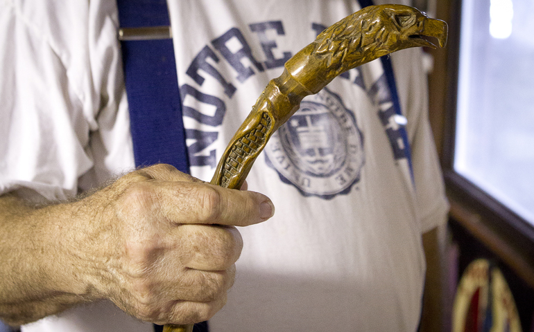 Les Johnson of Akron, Ohio, holds a walking stick with an eagle carved in the handle. (CNS/Dennis Sadowski)