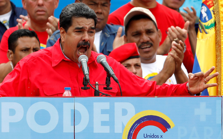 Venezuelan President Nicolas Maduro delivers a speech in Caracas during the closing campaign ceremony for the July 27 Constituent Assembly election. The banner reads "Power". (CNS/Carlos Garcias, Reuters)