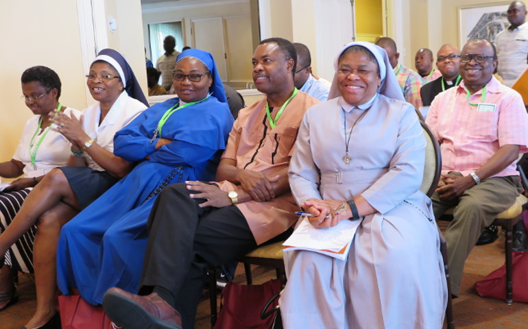 Sr. Joanna Okereke, a Handmaid of the Holy Child Jesus, who is program coordinator in the U.S. bishops' Secretariat for Cultural Diversity in the Church, center, listens to a speaker July 27. She was one of about 80 attendees at the 18th annual convention of the African Conference of Catholic Clergy and Religious in the United States in New Orleans. (CNS/Beth Donze, Clarion Herald) 