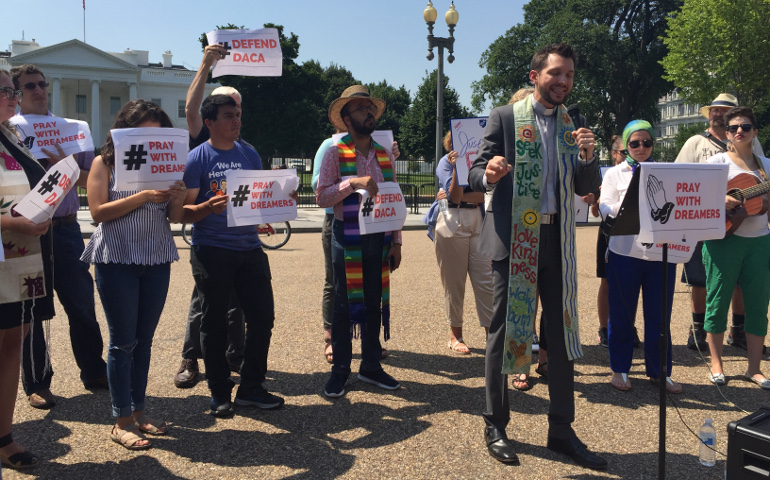 The Rev. Noel Andersen, of Church World Service in Washington, leads a group in prayer in front of the White House Aug. 2. Participants, who included Catholics, called on President Donald Trump to protect the Deferred Action for Childhood Arrivals program, known as DACA. (CNS/Rhina Guidos)