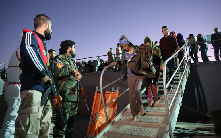 Migrants arrive at a naval base Nov. 24 in Tripoli, Libya, after the Libyan coast guard rescued them. (CNS/Reuters/Hani Amara)