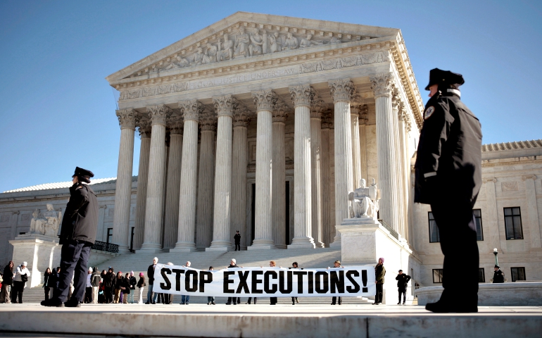 Protesters calling for an end to the death penalty unfurl a banner in late March 2017 outside the U.S. Supreme Court in Washington. (CNS/Reuters/Jason Reed)