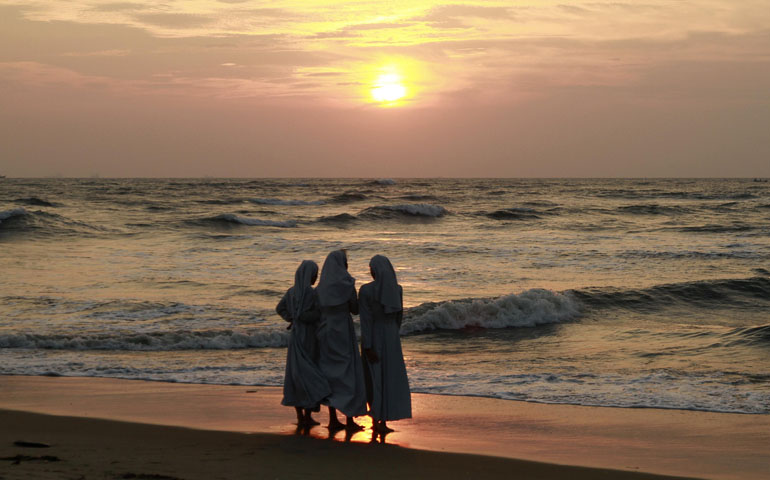 Nuns stand on a beach in Cochin, India, in this 2014 file photo. (CNS/Sivaram V, Reuters)