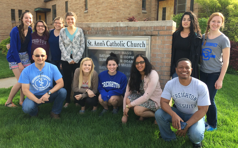 Divine Word Fr. Alexander Rödlach (front, left) with Creighton University students and Jesuit Fr. Renzo Rosales (front, right) at St. Ann's Parish in Lexington, Neb., May 10. (Courtesy of Fr. Alexander Rödlach, SVD)