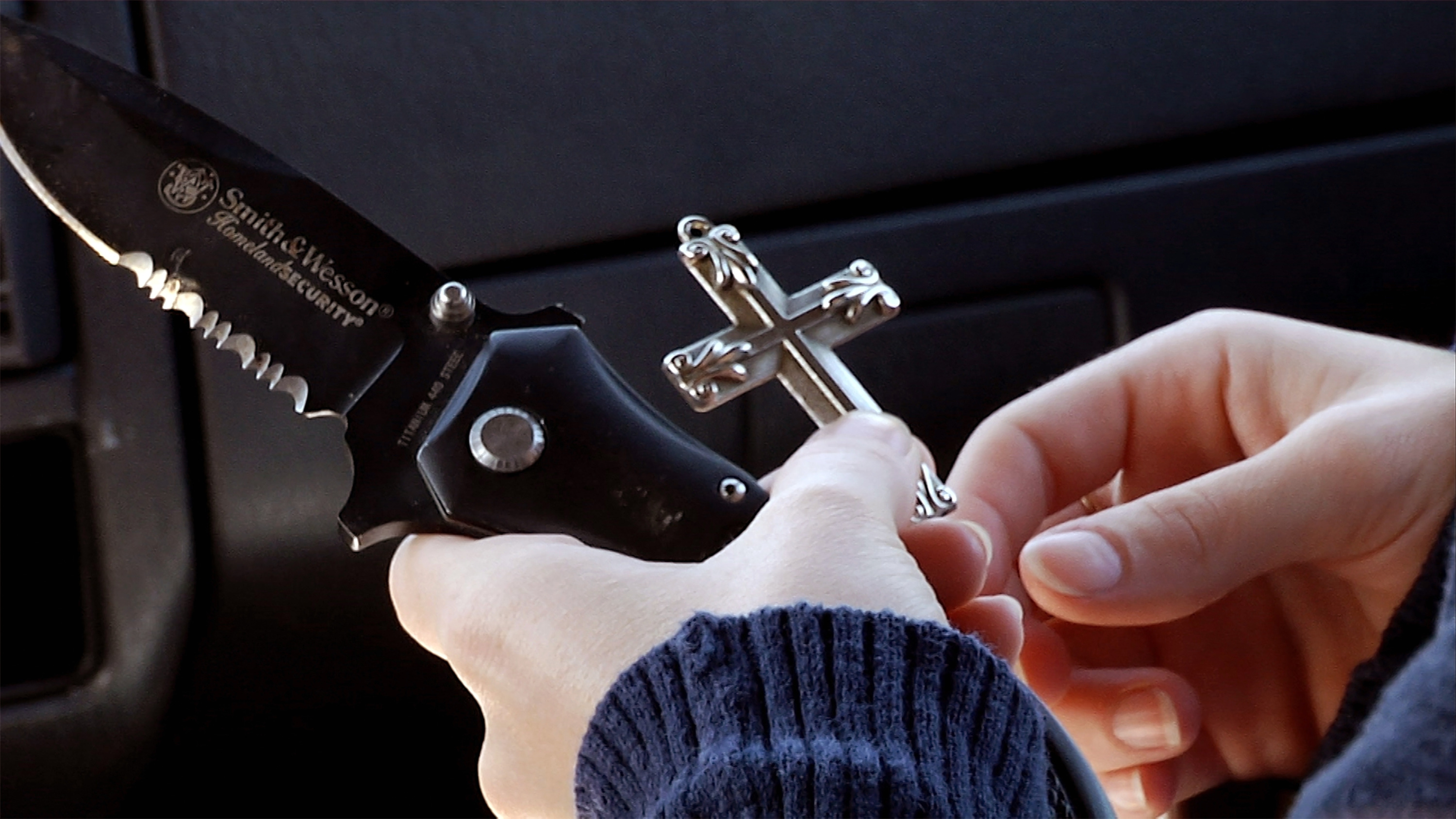 Former Coast Guard servicewoman Kori Cioca displays in the documentary "The Invisible War" two items constantly at her side since her attempted rape by a fellow Coast Guard service member: a cross and a Smith & Wesson knife. (Photo: courtesy Cinedigm/Docurama Films)