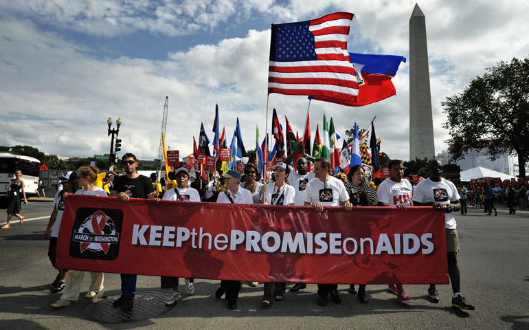 People march through the streets of Washington on July 22 to demand that the U.S. and other governments keep their promises to fund global relief programs for those living with HIV and AIDS. (CNS/Paul Jeffrey)