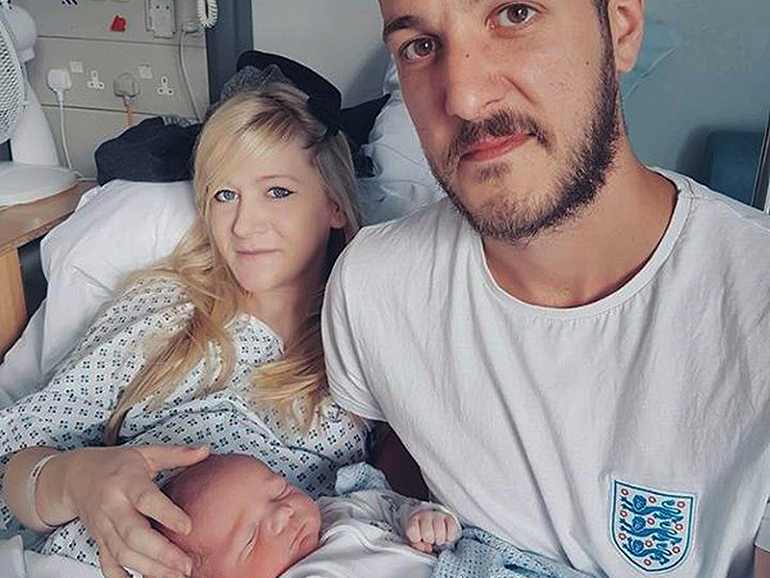This is an undated handout photo of Chris Gard and Connie Yates with their son, Charlie Gard, provided by the family, at Great Ormond Street Hospital in London. (Family of Charlie Gard via AP)