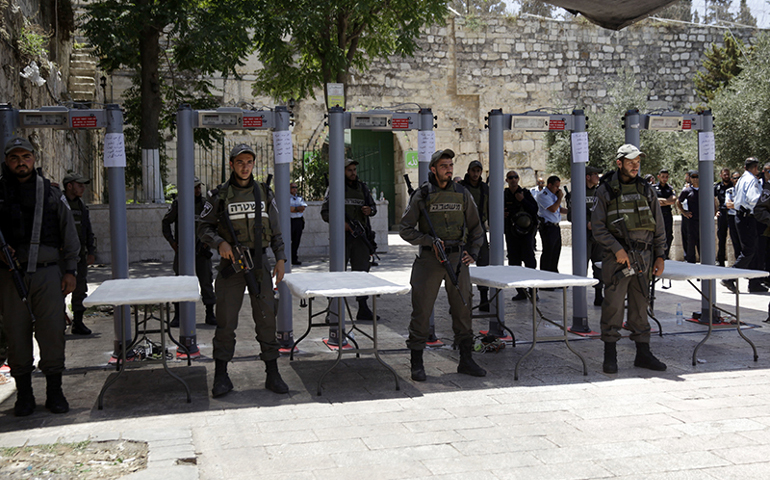 In this Sunday, July 16, 2017, file photo, Israeli border police officers stand guard near metal detectors at the entrance to the Al Aqsa Mosque compound in Jerusalem. A dispute over metal detectors has escalated into a new showdown between Israel and the Muslim world over a contested Jerusalem shrine that has been at the center of violent confrontations in the past. (AP Photo/Mahmoud Illean, File)