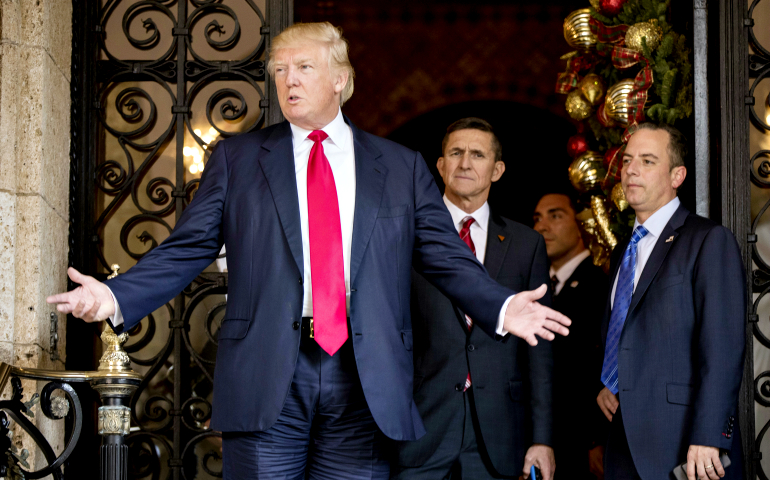 President-elect Donald Trump, accompanied by chief of staff Reince Priebus, right, and Michael Flynn, center, speaks to members of the media in Palm Beach, Fla., Dec. 21. (AP Photo/Andrew Harnik)
